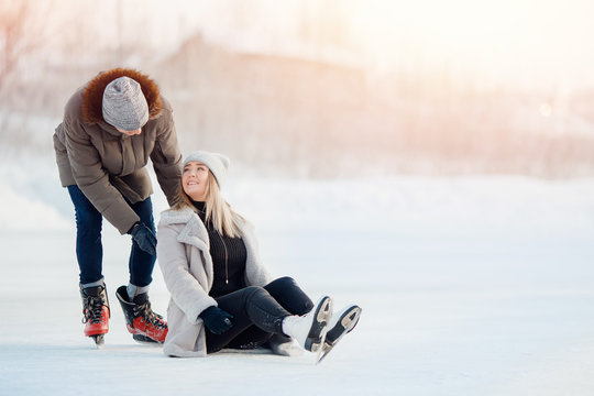 Girl Shows Guy Where She Has Pain After Fall Injury On Ice Skating Rink In Winter