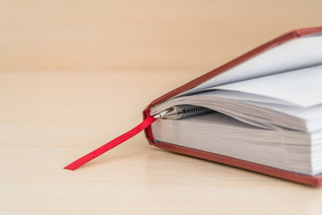 diary, Office Desk. Book layout blank leather case for magazine, booklet, brochure, diary, business portfolio layout design Template on a wooden background. business concept, diary and fountain pen