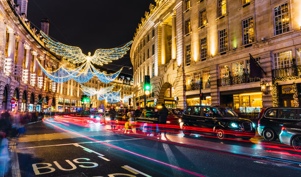 London, UK/Europe; 21/12/2019: Luminous Angels In Regent Street As Christmas Decoration. Long Exposure Shot With Car Trails And Blurred People.