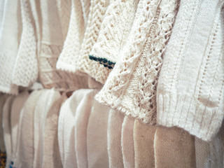 a row of wool knitted white socks . handmade work. the concept of zero waste. rustic style