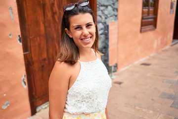 Young beautiful woman on romatic village walking on the town street on a sunny day