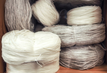 skeins of white and gray wool on the shelf in the store. the concept of zero waste