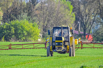 tractor in a field spraying crop