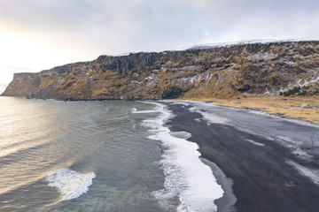 Black sand beach and cliffs in winter. Iceland