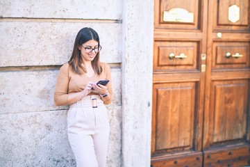 Young beautiful woman smiling happy and confident. Standing with smile on face leaning on the wall...
