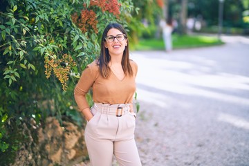 Young beautiful woman smiling happy and confident. Standing with smile on face at the town street