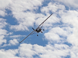 Yaslo, Poland - july 1 2018: A light sport turboprop aircraft flies across the sky among the rainy clouds. Landing in difficult weather conditions. Meteorology and weather forecast for aviation