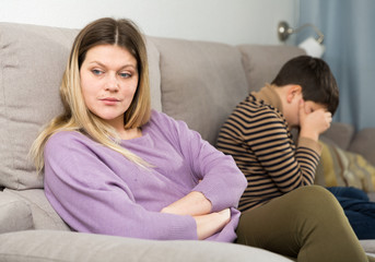 Upset mother and  offended son crying after  quarrel at home