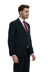 sexy young businessman looking to side and waiting in line