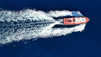 Naklejka premium Aerial drone photo of pilot tug vessel cruising in Mediterranean container logistics port