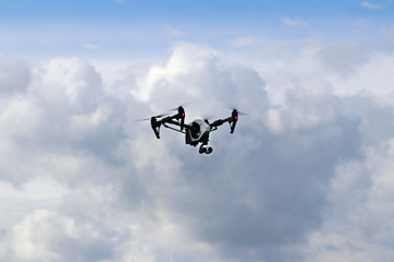 Fototapeta na wymiar Yaslo, Poland - july 1 2018: The flight of a drone DJI X pair with video camera among the rainy clouds. Difficult weather conditions for aircraft. Use of new technologies and competition of robotics