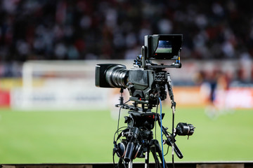 TV camera at the stadium, broadcasting during a football (soccer) match