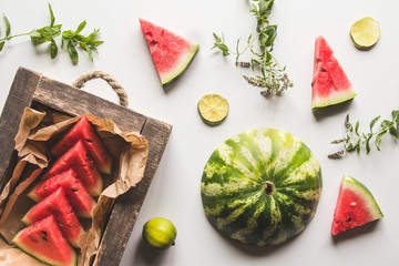sliced watermelon with mint and lime on a white background. Fresh food. Fruits