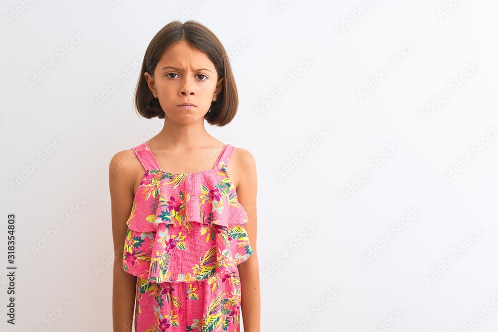 Sticker young beautiful child girl wearing pink floral dress standing over isolated white background skeptic