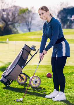 Female Golf Player Getting Ready To Hit Ball