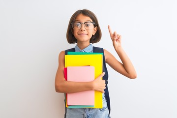 Beautiful student child girl wearing backpack glasses books over isolated white background surprised with an idea or question pointing finger with happy face, number one