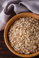 raw oatmeal on a wooden rustic background