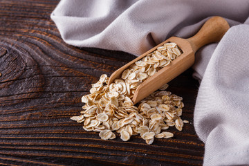 raw oatmeal on a wooden rustic background