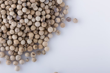 white peppercorns seed on white acrylic background