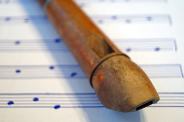 Close-Up Of Flute On Sheet Music