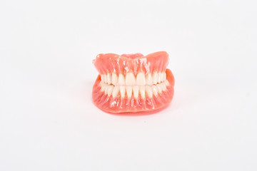 False prostheses. Dental hygienist checkup concept. Full removable plastic denture of the lower jaw.