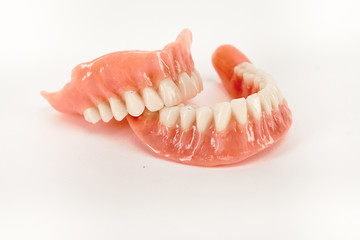 False prostheses. Dental hygienist checkup concept. Full removable plastic denture of the lower jaw.
