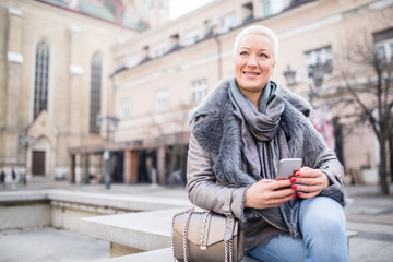 Woman on the street uses a cellphone