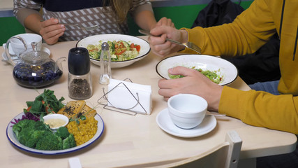 couple man and woman eating in vegetarian restaurants healthy food