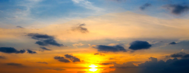 Cloudy sky and bright sunrise over the horizon. Wide photo.
