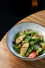 Halloumi cheese salad with mixed greens and tomatoes top view