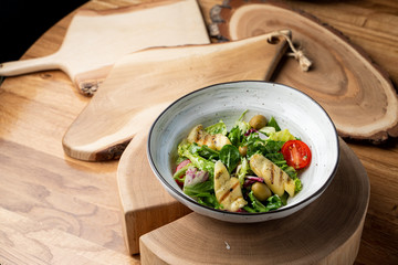 Halloumi cheese salad with mixed greens and tomatoes top view