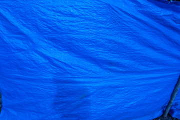 blue plastic tarp with folds - obrazy, fototapety, plakaty