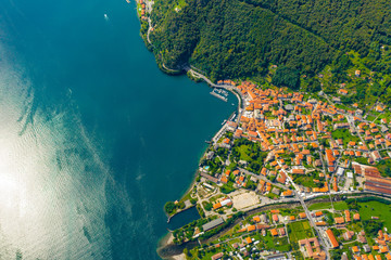 Fototapeta na wymiar Aerial view of Como lake, Dongo, Italy. Coastline is washed by blue turquoise water