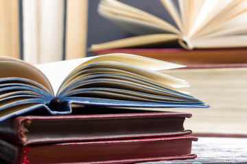 Open book, hardback books on wooden table. Back to school. Copy space