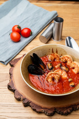 Hot and spicy tomato soup with king prawns and scallops and garlic