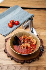 Hot and spicy tomato soup with king prawns and scallops and garlic
