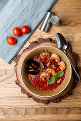 Hot and spicy tomato soup with king prawns and scallops and garlic