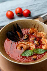 Hot and spicy tomato soup with king prawns and scallops and garlic