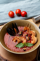Hot and spicy tomato soup with king prawns and scallops and garlic