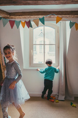 Cheerful healthy children. Christmas morning with kids opening presents from Santa Claus. Family...