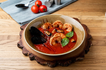Hot and spicy tomato soup with king prawns and scallops and garlic