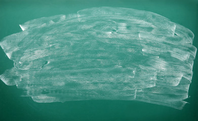 Chalk rubbed out on green board. Space for text