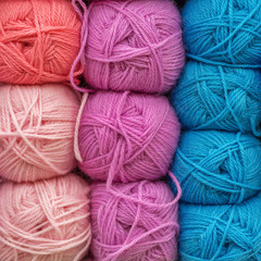 Multicolored wool balls of yarn. Background of colored yarn balls. Embroidery. Knitting.