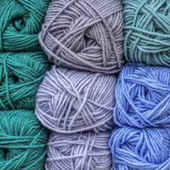 Multicolored wool balls of yarn. Background of colored yarn balls. Embroidery. Knitting.