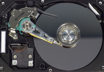 Disassemble a hard drive from a computer, a hard drive with a mirror effect a hard drive from a computer, a hard drive with a mirror effect Part of a computer, close-up HDD