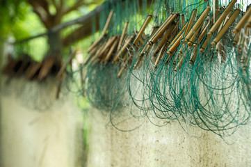 Close-up at texture of thin rustic fishing nets drying outdoor.
