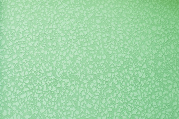 Old peeling plastered surface in green. For background and texture