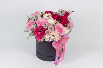 Fresh arrangement of vibrant flowers close-up work florist light background