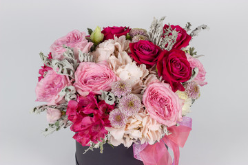 Fresh arrangement of vibrant flowers close-up work florist light background