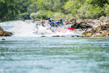 Rafting team goes down the river on the beautiful sunny day.